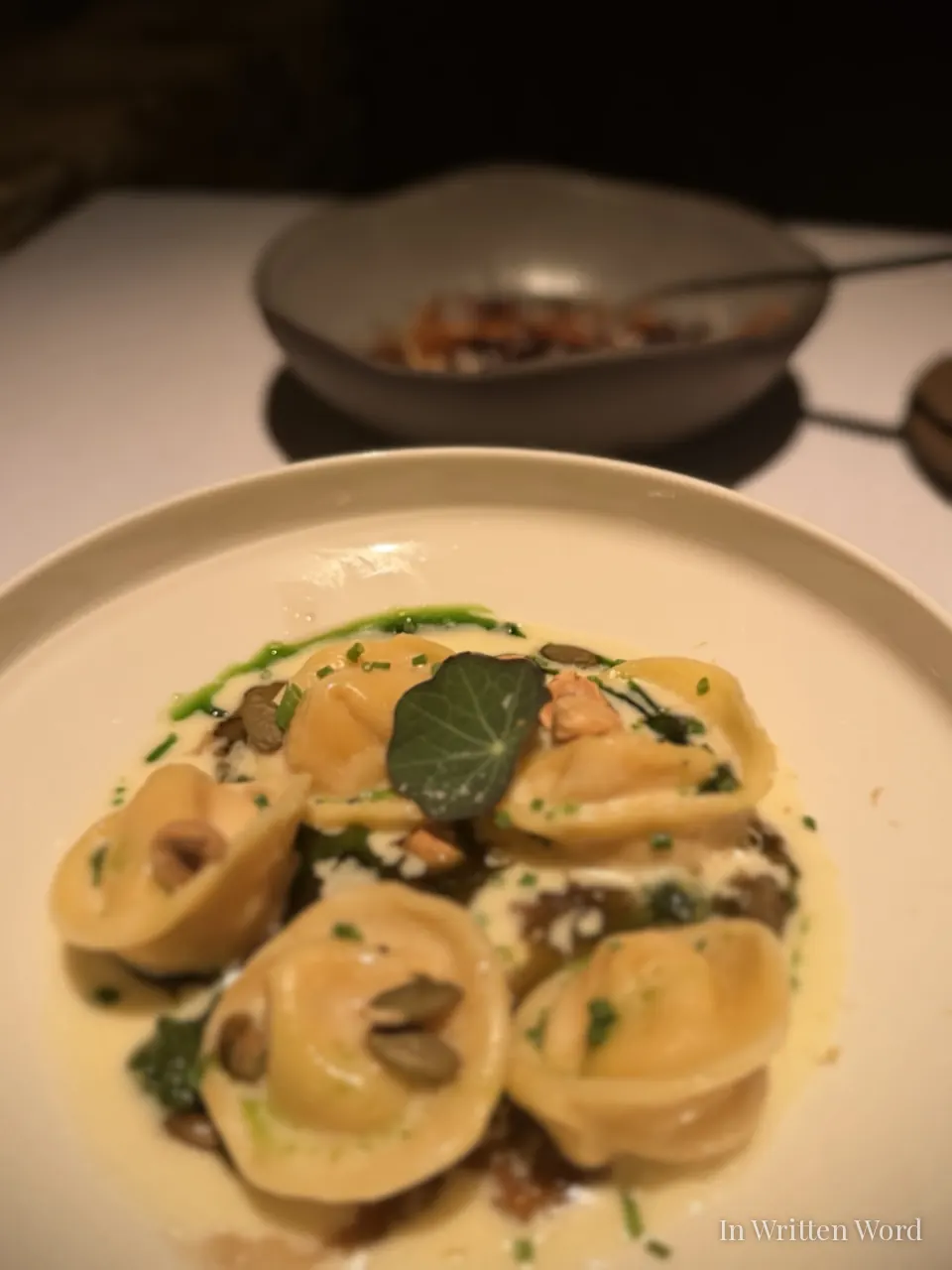 Manti dumplings served in a pool of brown butter and yogurt with wild mushroom, nasturtium leaf, and a drizzle of green herb oil at Aheste restaurant in Istanbul
